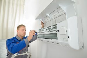 Technician repairing mini split air conditioning services 