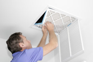 Man replacing dirty air filter