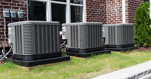 Image: three condensers side by side. HELP provides the best Beavercreek Air Conditioning Services for local residents.