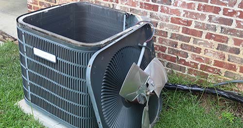 Image: an air conditioner with it's fan off during a tune-up. For the best Bellbrook air conditioner repairs, call HELP!