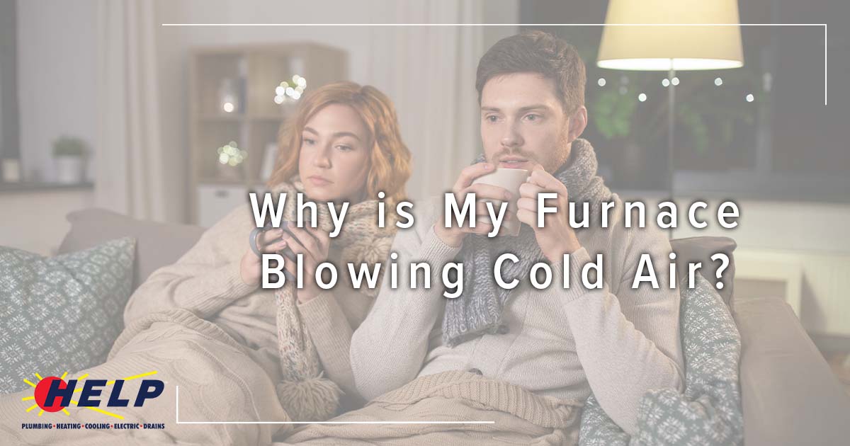 Image: couple bundled up on the couch with warm drinks, cover image for Why is My Furnace Blowing Cold Air?
