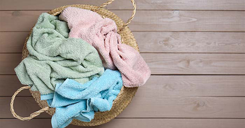 Image: a hamper full of used gym towels.