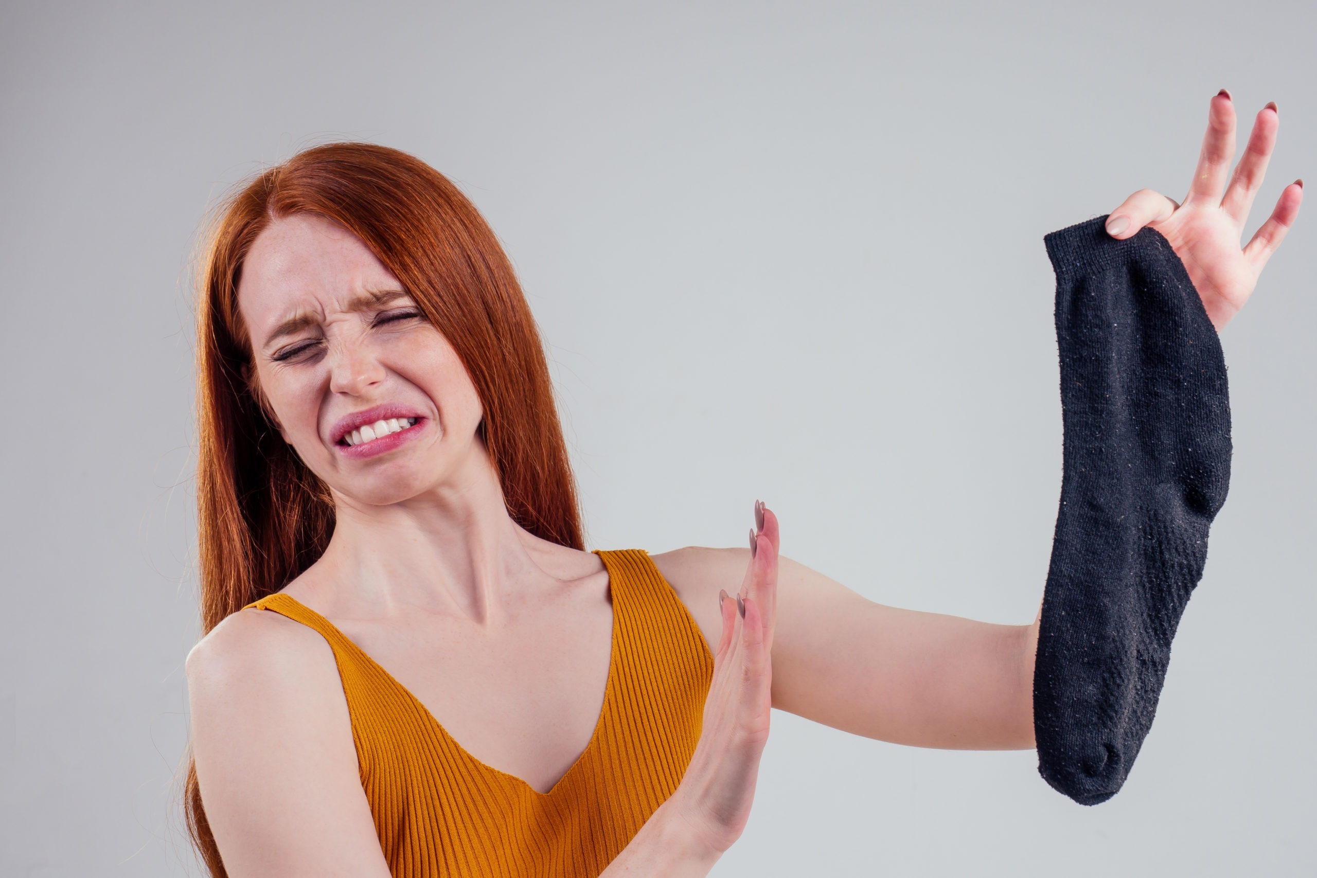 woman holding a smelly sticky sock