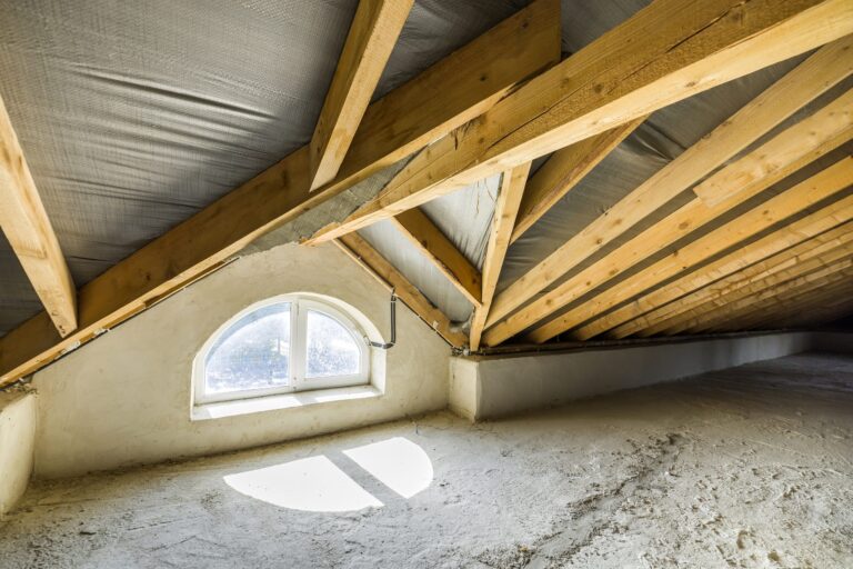 An attic with exposed wooden beams and a small arched window allows sunlight to illuminate the dusty floor, while a persistent chill lingers due to the furnace pilot light that keeps going out.