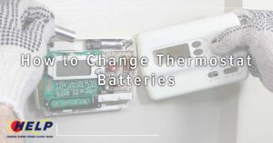 Wearing gloves, a person replaces batteries in a digital thermostat. Text overlay reads: "How to Change Thermostat Batteries." Don't forget your drain during spring cleaning! The HELP logo is displayed at the bottom left.